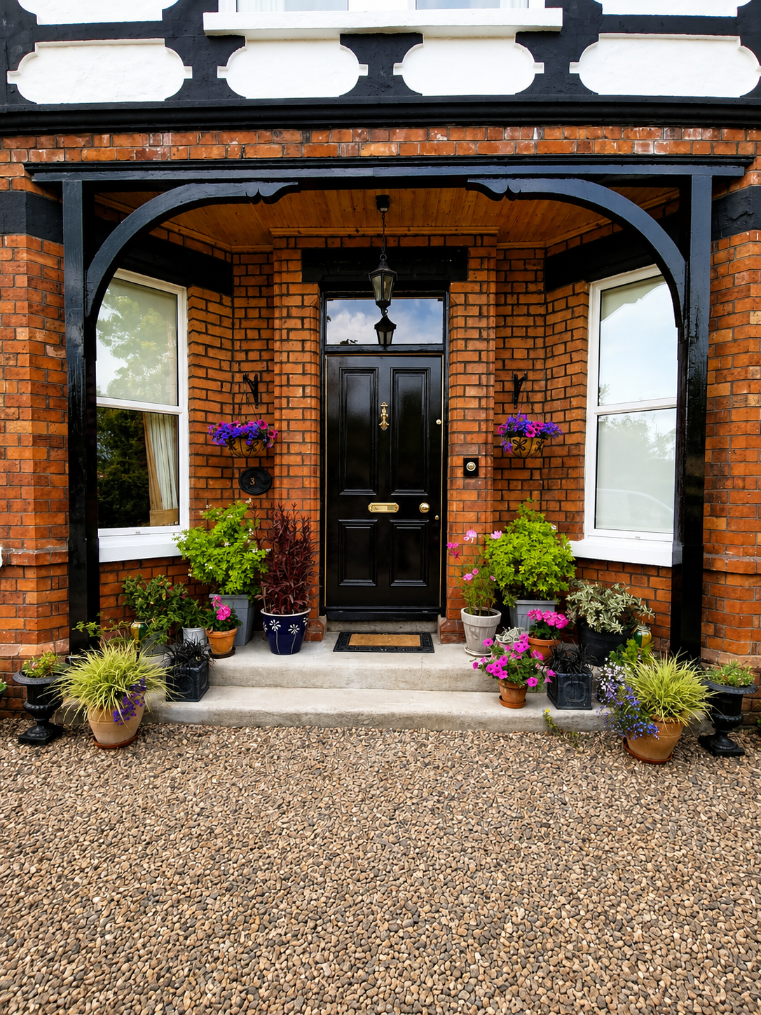 Completed exterior repainting Bangor — front entrance with repainted porch arch, black door and decorative render